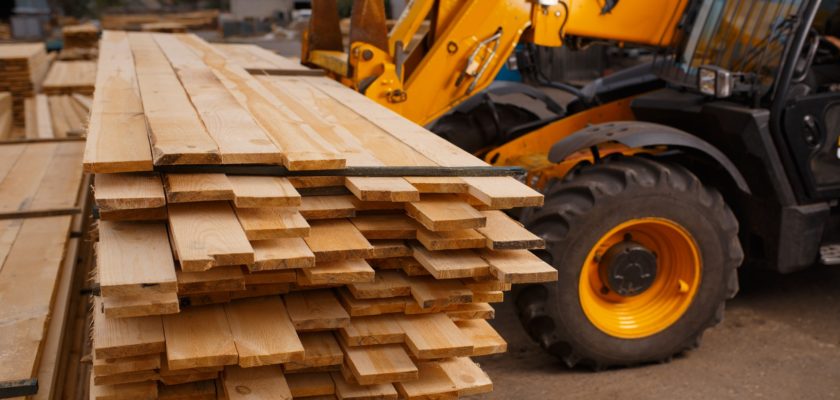 Forklift loads the boards in the lumber yard